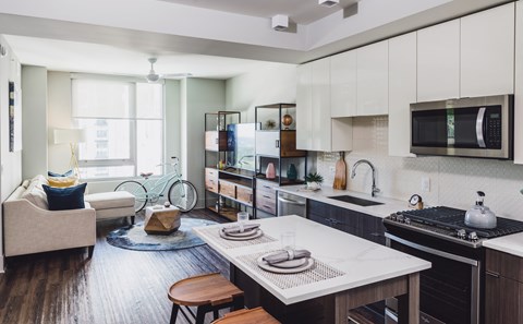 a kitchen and living room with a table and a sink